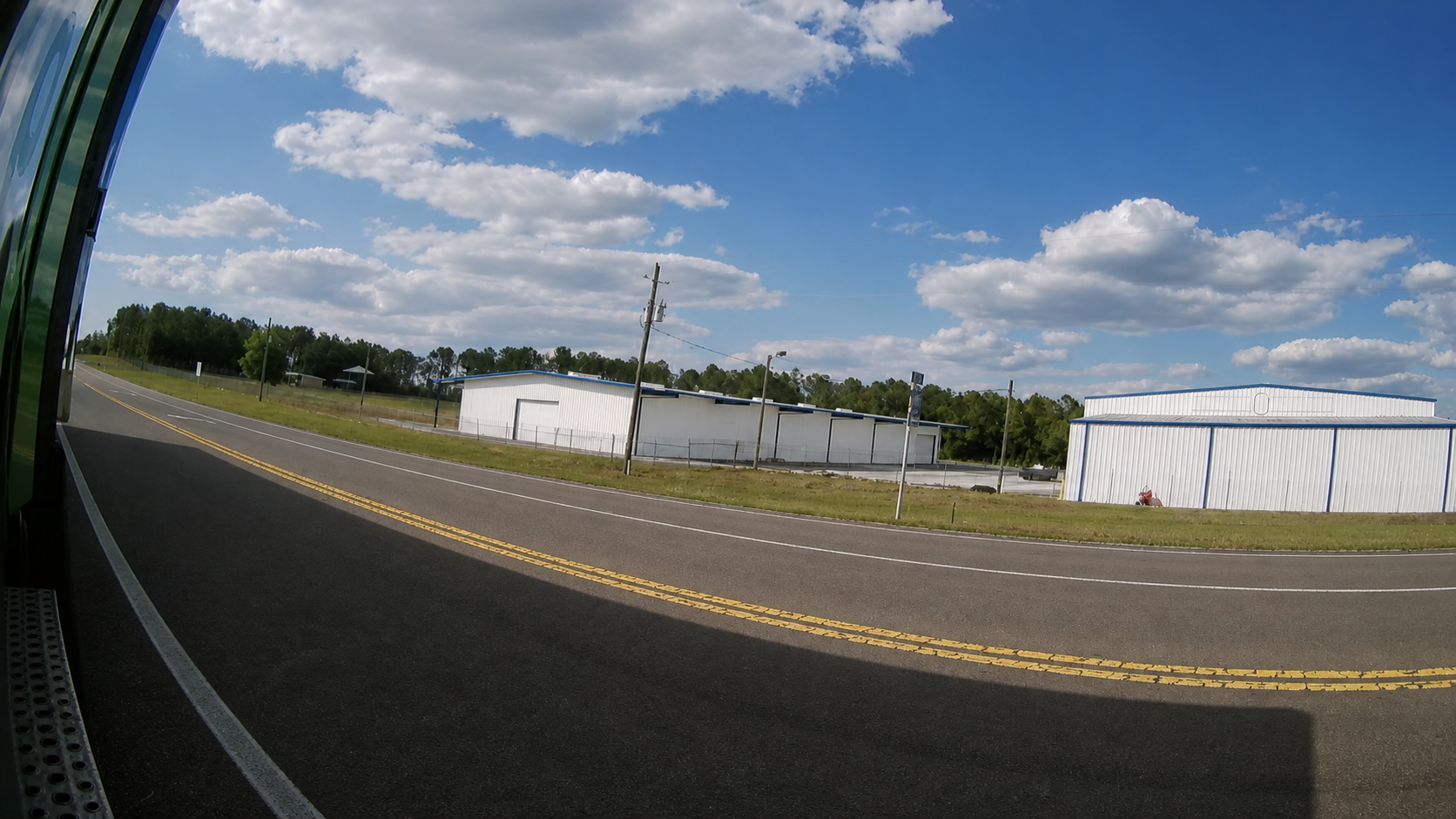 Clean rearward roadway view from the F1 driver-side fender camera.