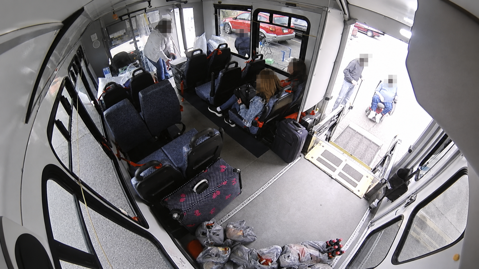 Cleaned C4 paratransit wheelchair-lift view with every visible face anonymized.