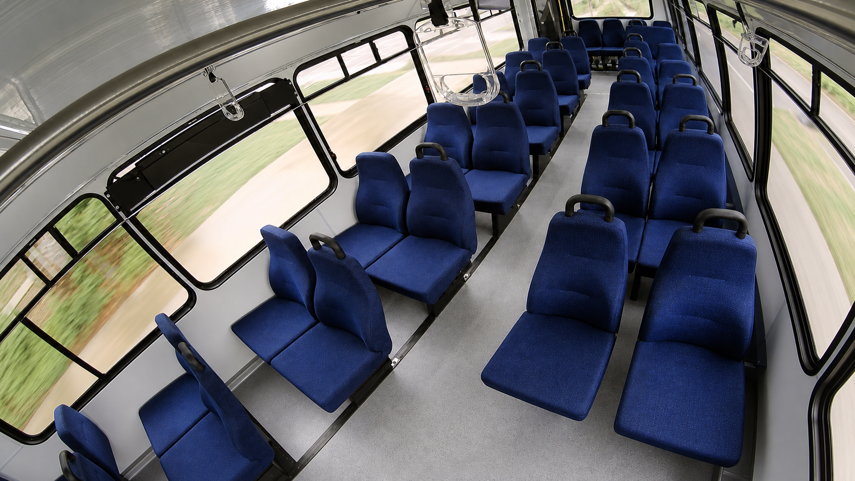 Restored and sharpened C3 angled wide-angle transit interior view showing the complete right-side seating row and aisle coverage.