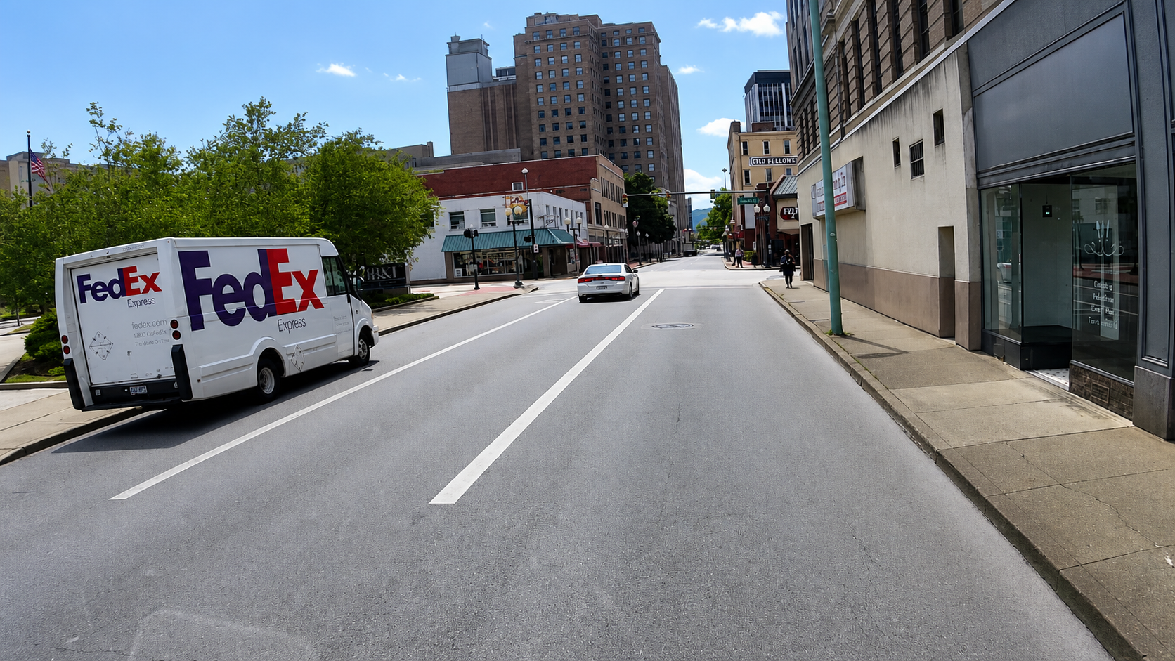 Sharpened C5 forward windshield transit camera view along a downtown street.